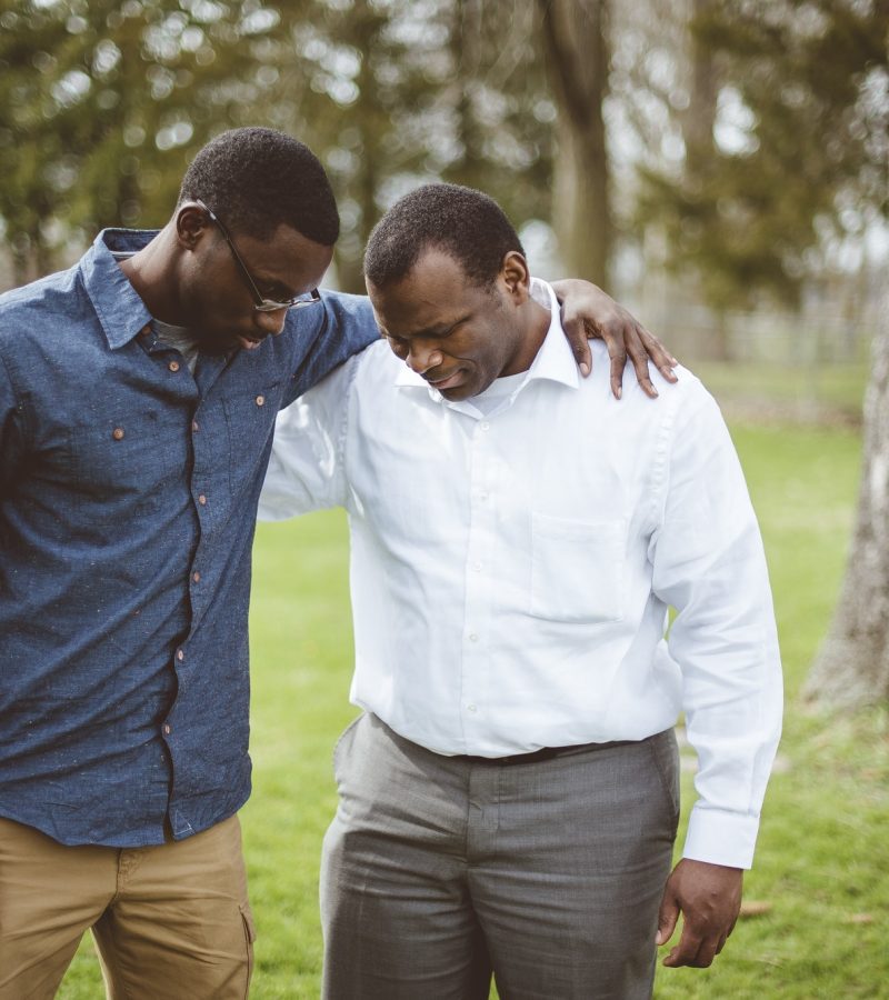 african-american-male-friends-standing-with-their-hands-on-the-shoulders-and-praying.jpg