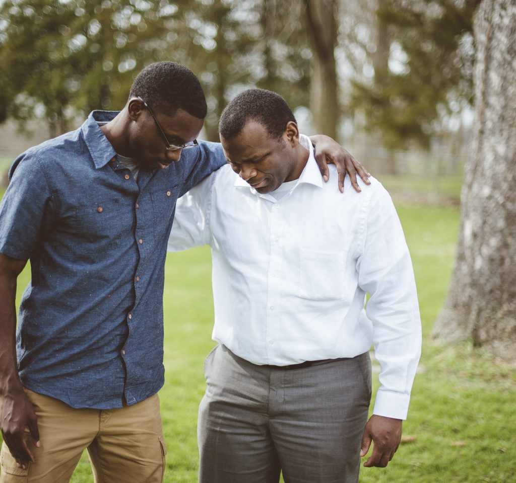 african-american-male-friends-standing-with-their-hands-on-the-shoulders-and-praying.jpg