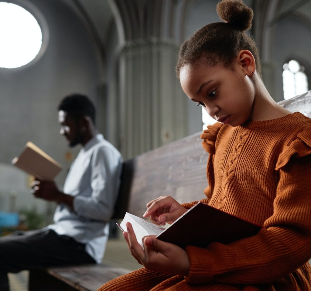 little-girl-reading-bible-in-church.jpg